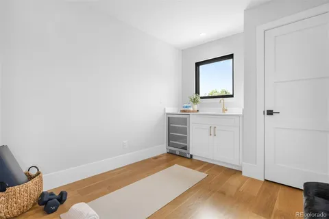 a view of a room with wooden floor and cabinet