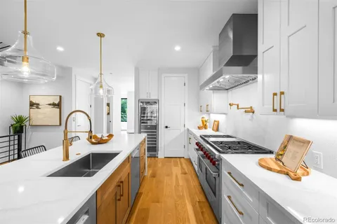 a kitchen with stainless steel appliances kitchen island a white stove top oven and sink
