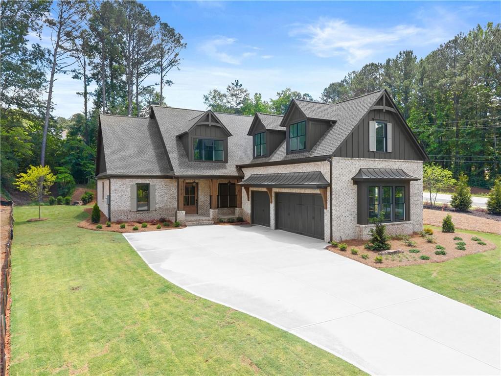 285 Reese Way Ball Ground, GA 30107 - Photo 1 of 30 a front view of house with yard outdoor seating and green space