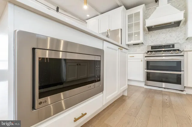 a view of a kitchen with a sink and wooden floor