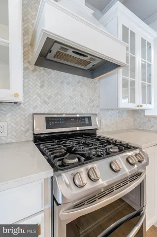 a kitchen with granite countertop a stove and a sink