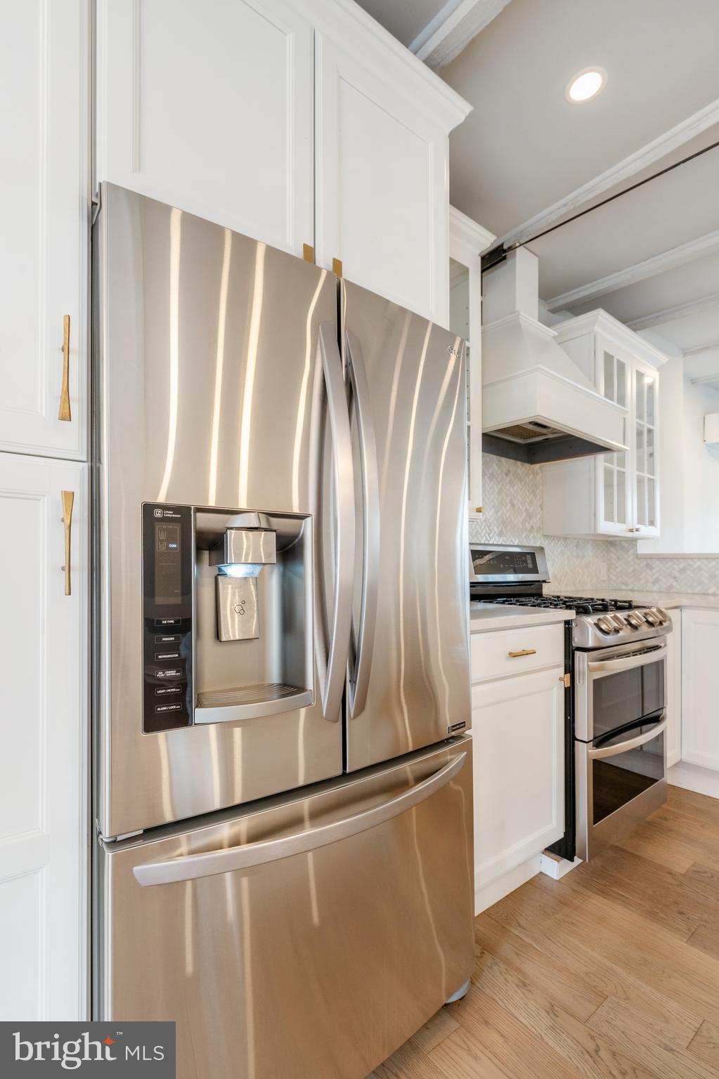 2314 South Street Philadelphia, PA 19146 - Photo 15 of 83 a kitchen with stainless steel appliances wooden floor and a refrigerator