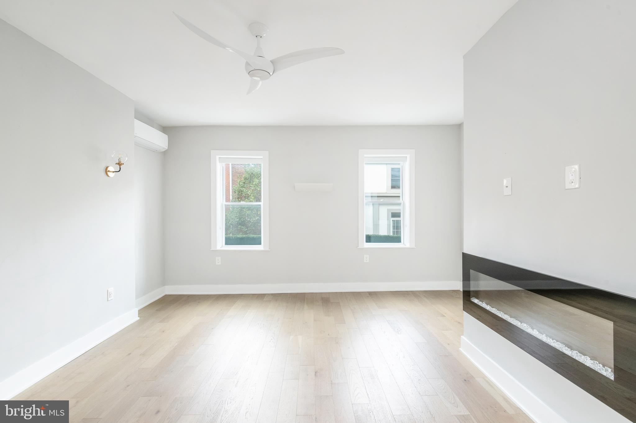 2314 South Street Philadelphia, PA 19146 - Photo 32 of 83 an empty room with wooden floor and windows
