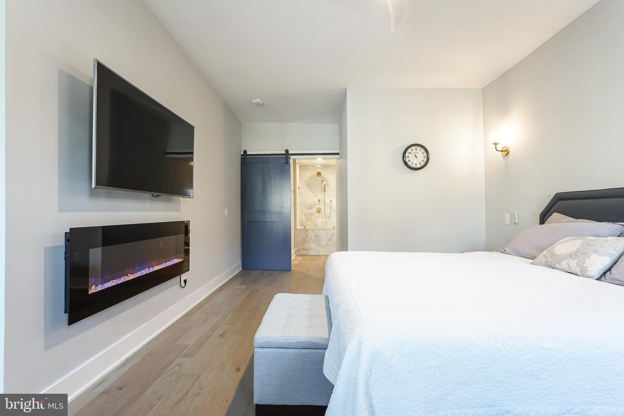 2314 South Street Philadelphia, PA 19146 - Photo 35 of 83 a bedroom with a bed and a flat screen tv