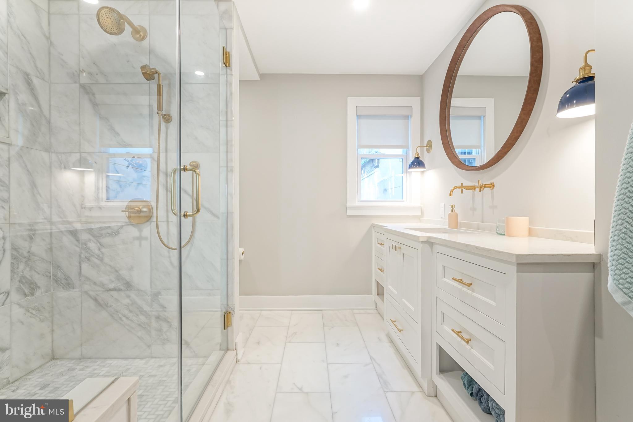 2314 South Street Philadelphia, PA 19146 - Photo 43 of 83 a bathroom with a double vanity sink mirror and a shower