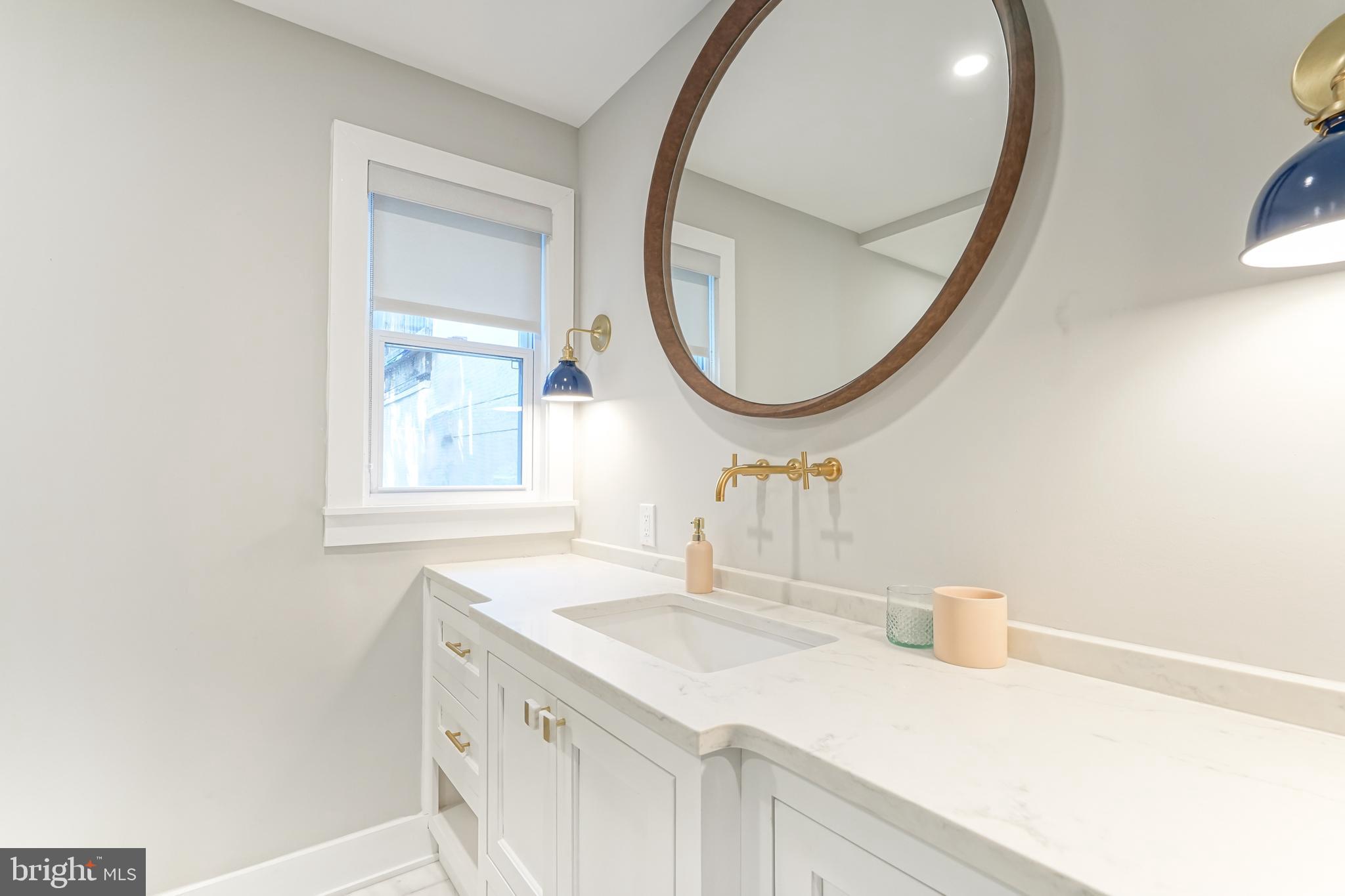 2314 South Street Philadelphia, PA 19146 - Photo 45 of 83 a bathroom with a sink and a mirror