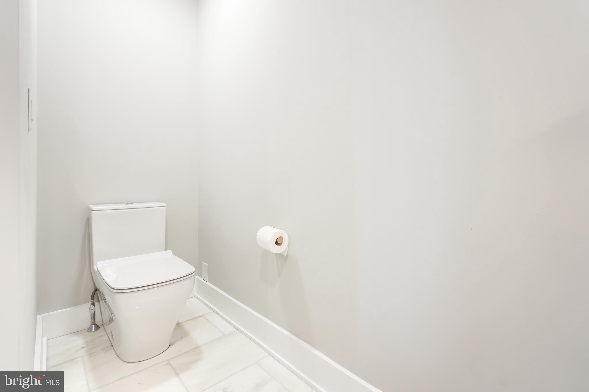 2314 South Street Philadelphia, PA 19146 - Photo 49 of 83 a white toilet sitting next to a white walls