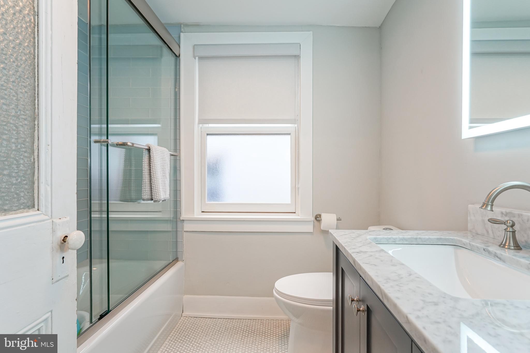 2314 South Street Philadelphia, PA 19146 - Photo 63 of 83 a bathroom with a granite countertop sink toilet and shower
