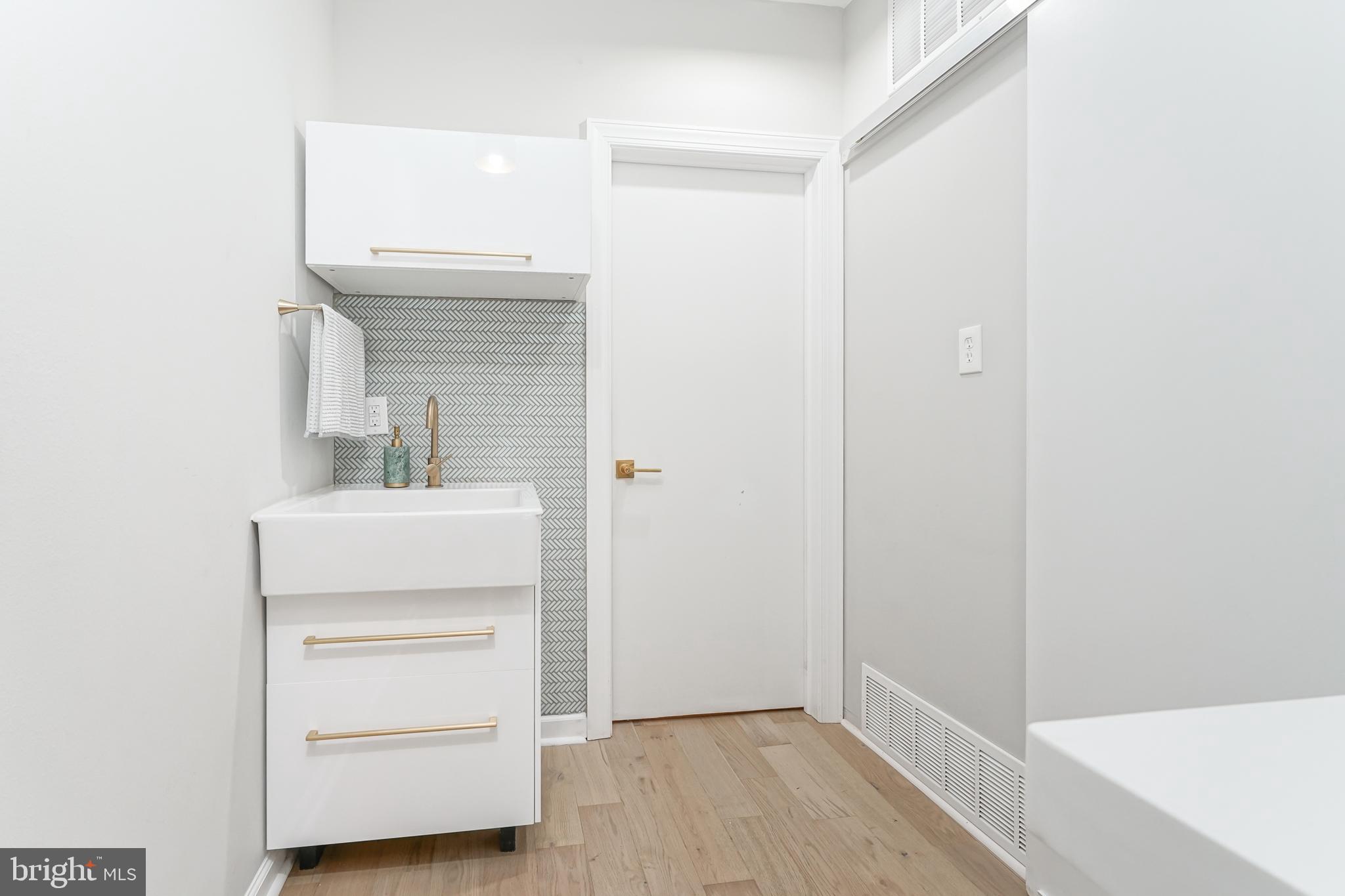 2314 South Street Philadelphia, PA 19146 - Photo 73 of 83 a bathroom with a sink a mirror and vanity