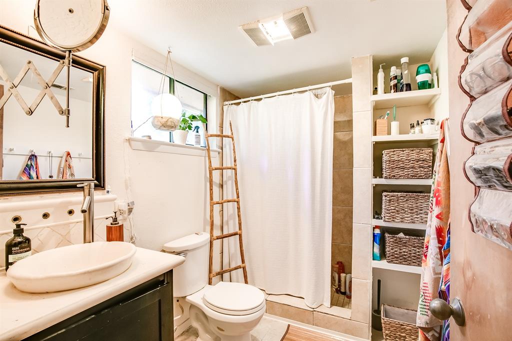 2400 Thornton Road, Unit A Austin, TX 78704 - Photo 11 of 13 Bathroom featuring a stall shower, vanity, and decorative backsplash