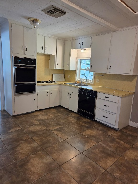 417 West Lewis Street Conroe, TX 77301 - Photo 5 of 11 a kitchen with stainless steel appliances a stove sink and cabinets