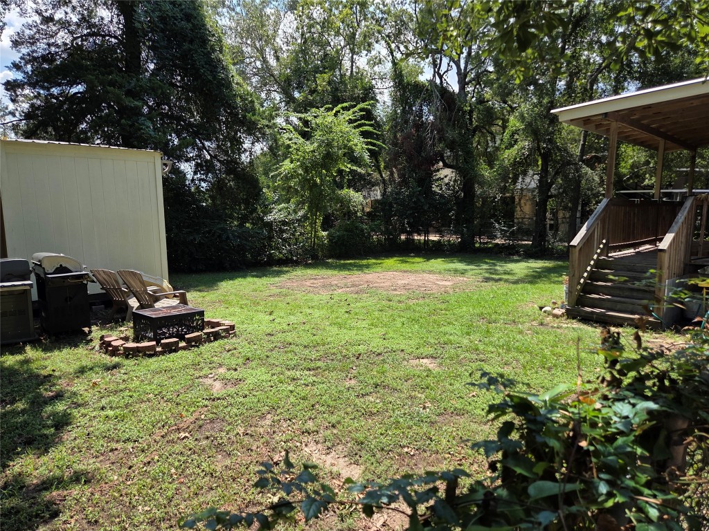 417 West Lewis Street Conroe, TX 77301 - Photo 8 of 11 a view of a backyard with sitting area