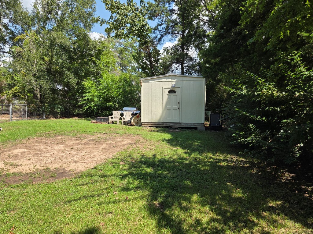 417 West Lewis Street Conroe, TX 77301 - Photo 9 of 11 a small garden covered with tall trees