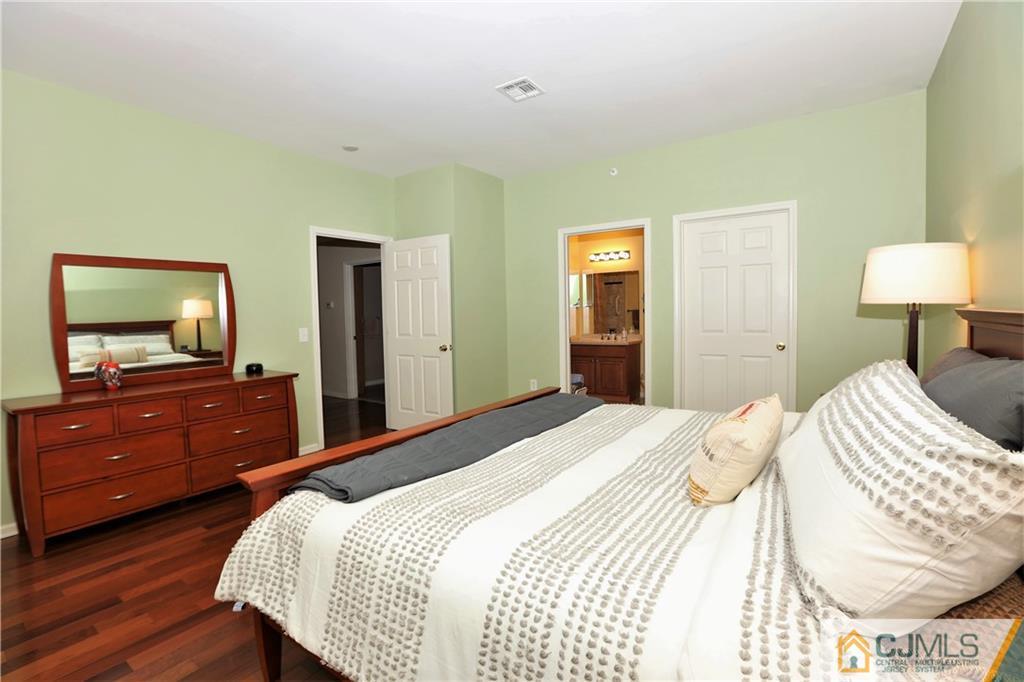 358 Rector Street, Unit 219 Perth Amboy, NJ 08861 - Photo 11 of 17 a bedroom with a bed and a dresser