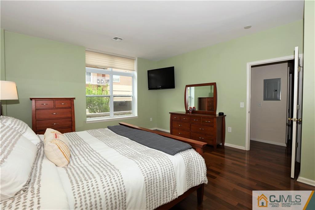 358 Rector Street, Unit 219 Perth Amboy, NJ 08861 - Photo 12 of 17 a bedroom with a bed and a television