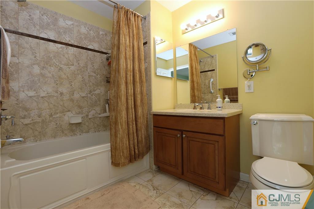 358 Rector Street, Unit 219 Perth Amboy, NJ 08861 - Photo 13 of 17 a bathroom with a sink a toilet and shower