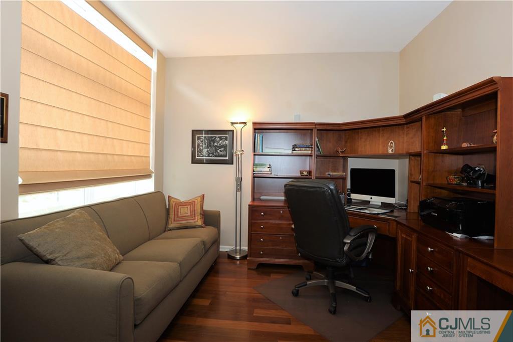 358 Rector Street, Unit 219 Perth Amboy, NJ 08861 - Photo 15 of 17 a living room with furniture and a flat screen tv