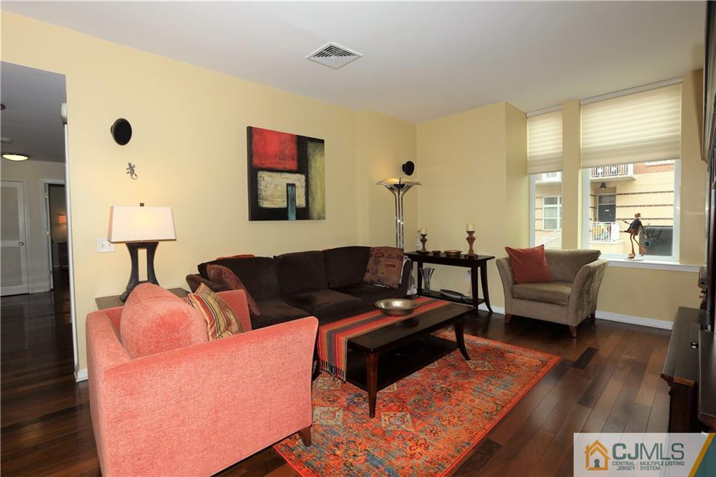 358 Rector Street, Unit 219 Perth Amboy, NJ 08861 - Photo 3 of 17 a living room with furniture and a large window
