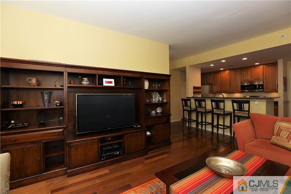 358 Rector Street, Unit 219 Perth Amboy, NJ 08861 - Photo 5 of 17 a living room with furniture and a flat screen tv