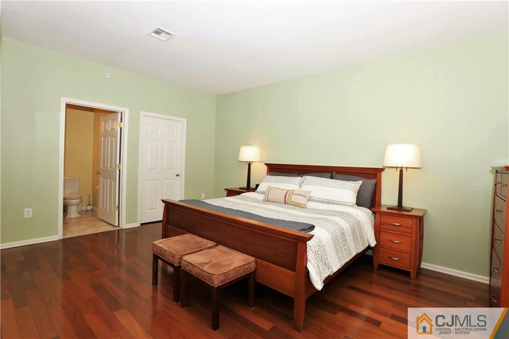 358 Rector Street, Unit 219 Perth Amboy, NJ 08861 - Photo 10 of 17 a bedroom with a bed and wooden floor