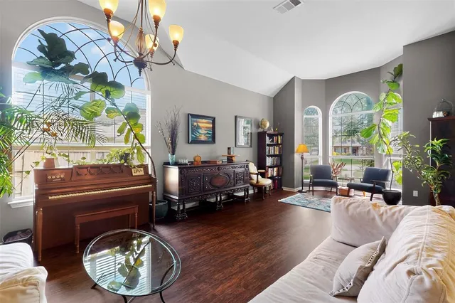 a living room with furniture and a chandelier