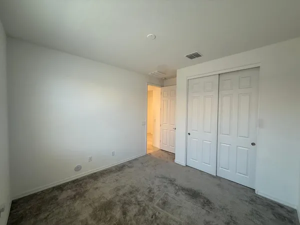 a view of an empty room and entryway