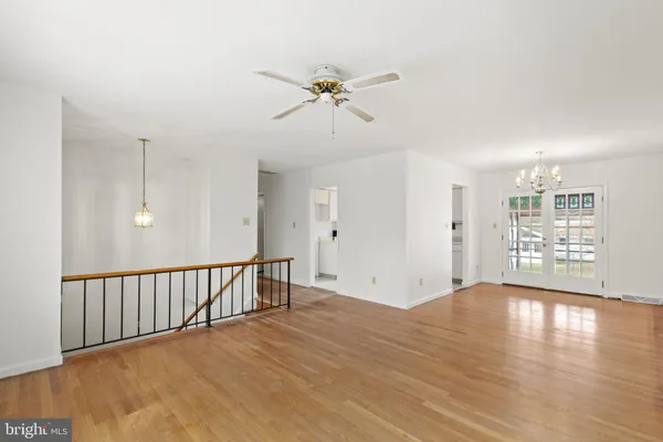a view of a livingroom with a window and wooden floor