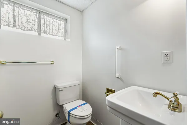 a white toilet sitting next to a bathroom sink
