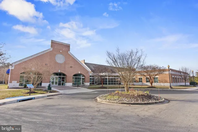 a swimming pool with outdoor seating and yard in the back