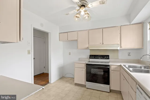 a kitchen with cabinets stainless steel appliances and a sink