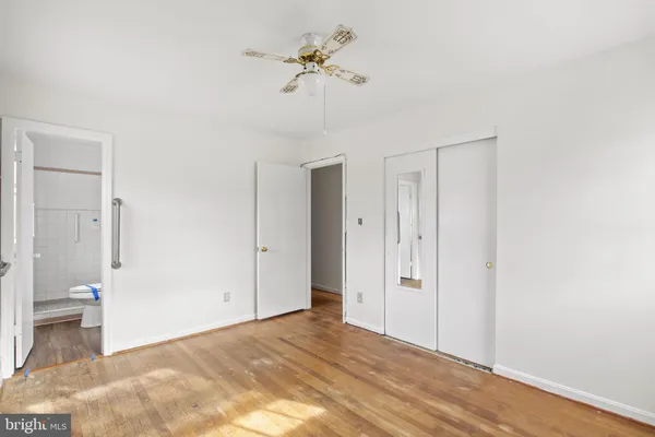 a view of a room with a stylish ceiling fan and entryway