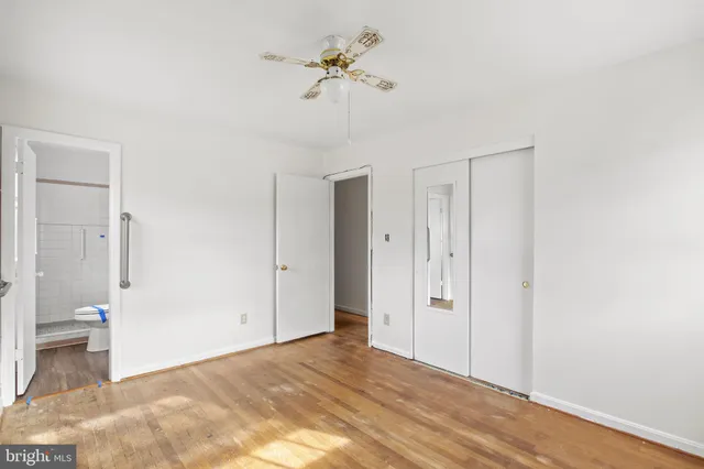 a view of a room with a stylish ceiling fan and entryway