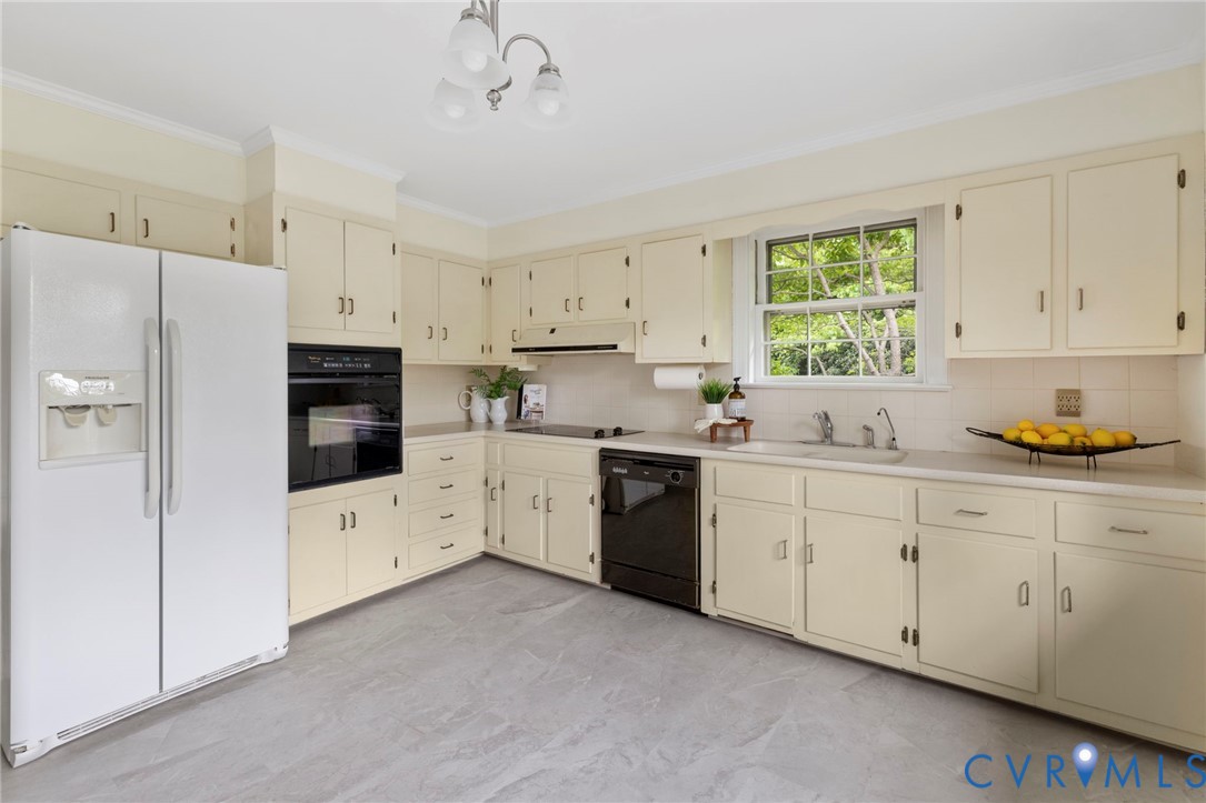 3140 Archdale Road Richmond, VA 23235 - Photo 13 of 48 a kitchen with cabinets appliances a sink and a window