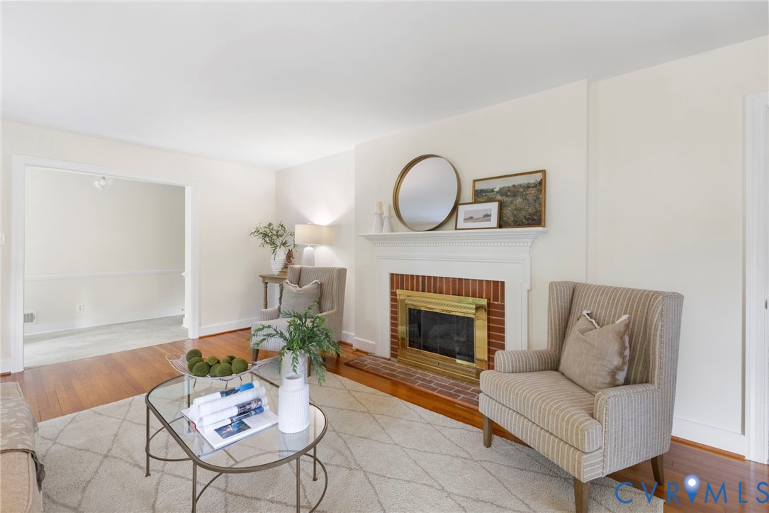 3140 Archdale Road Richmond, VA 23235 - Photo 7 of 48 a living room with furniture a fireplace and a potted plant