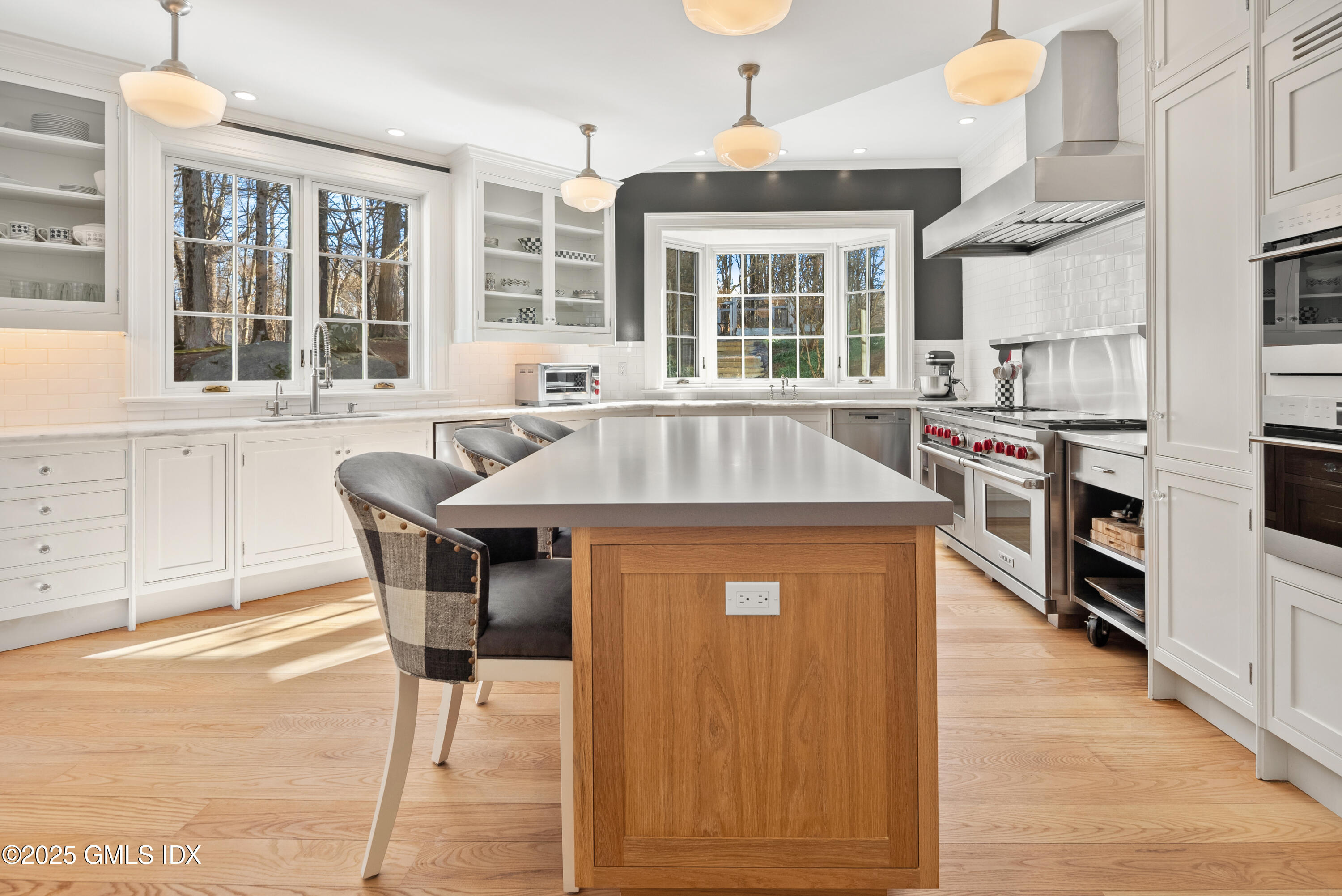 70 Sumner Road Greenwich, CT 06831 - Photo 22 of 57 a kitchen with stainless steel appliances granite countertop a stove top oven a sink a dining table and chairs