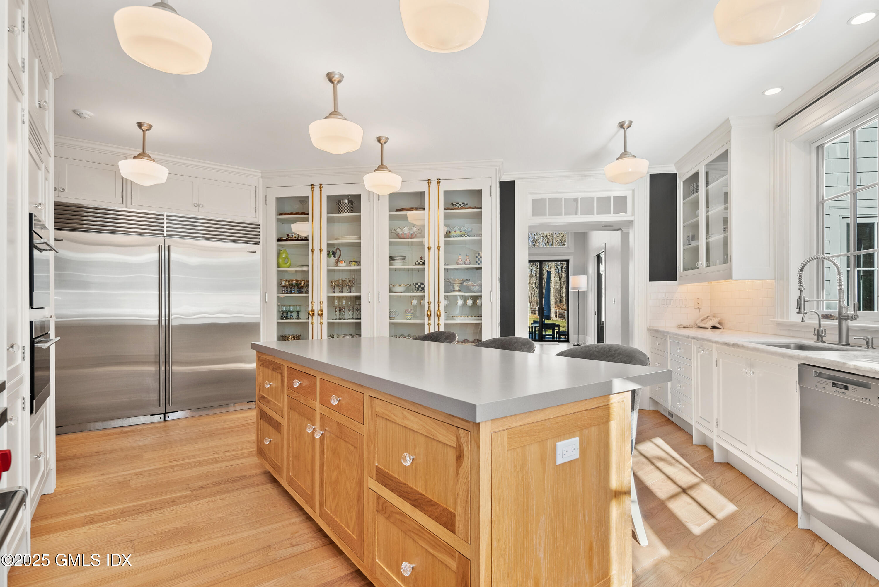 70 Sumner Road Greenwich, CT 06831 - Photo 24 of 57 a large kitchen with kitchen island a large counter space and stainless steel appliances