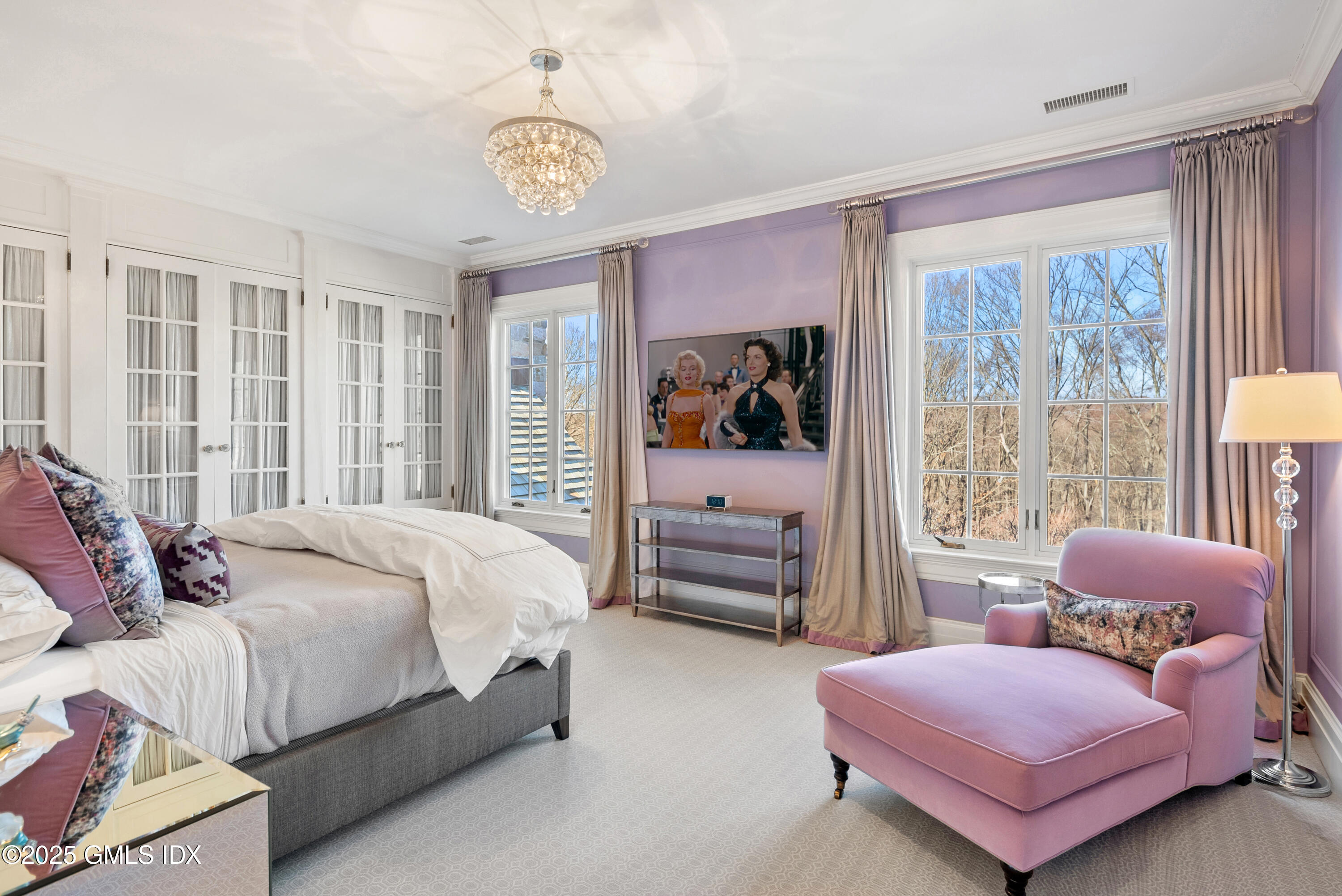 70 Sumner Road Greenwich, CT 06831 - Photo 31 of 57 a spacious bedroom with a bed and a chandelier