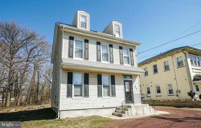 a front view of a residential apartment building with a yard
