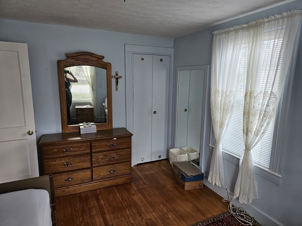 30 Donlon Street Framingham, MA 01701 - Photo 13 of 17 a room with wooden floor and furniture