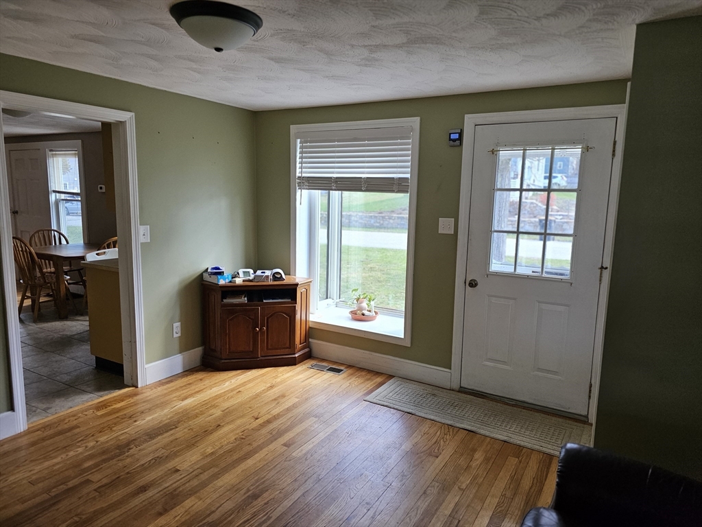 30 Donlon Street Framingham, MA 01701 - Photo 3 of 17 a kitchen with a wooden floor and a large window