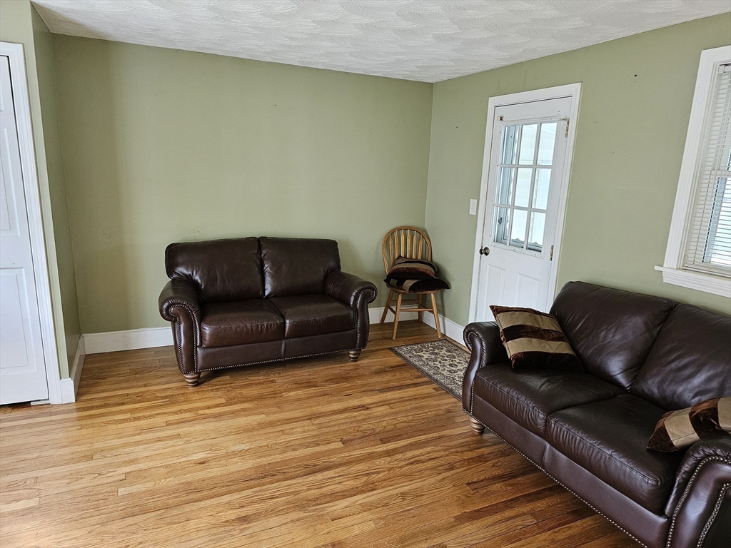 30 Donlon Street Framingham, MA 01701 - Photo 4 of 17 a living room with furniture and a wooden floor