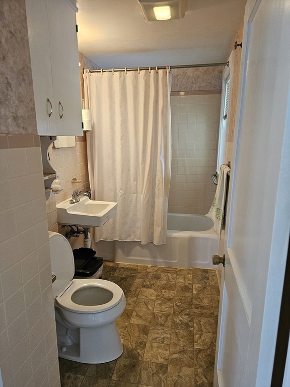 30 Donlon Street Framingham, MA 01701 - Photo 9 of 17 a bathroom with a sink a toilet a mirror and shower