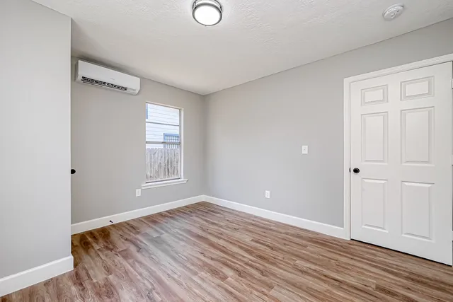 a view of room with window and wooden floor