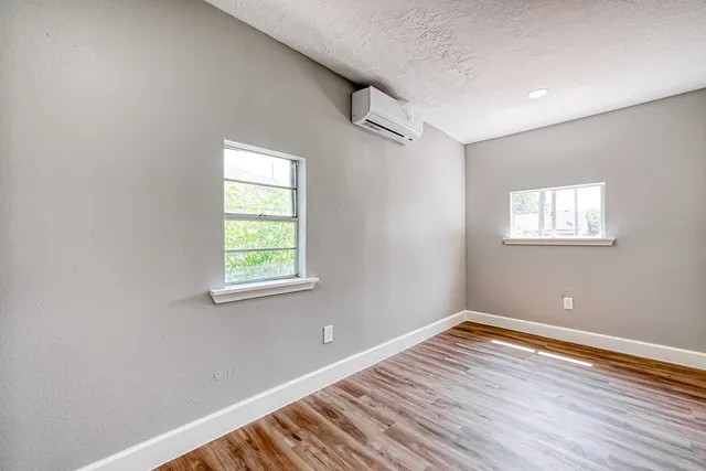 a view of a room with wooden floor and windows