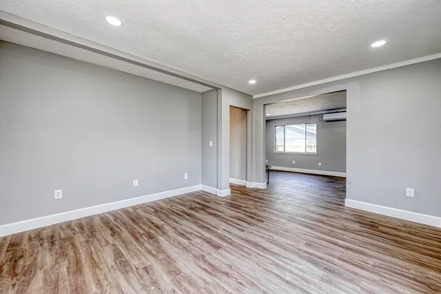wooden floor in an empty room with a window