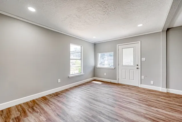 wooden floor in an empty room with a window