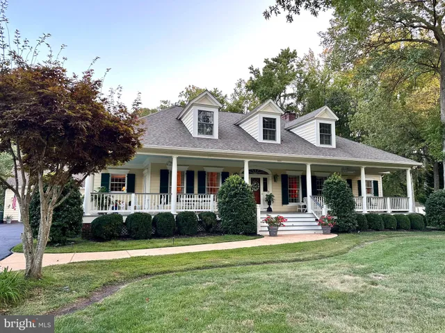 a front view of a house with a yard table and chairs