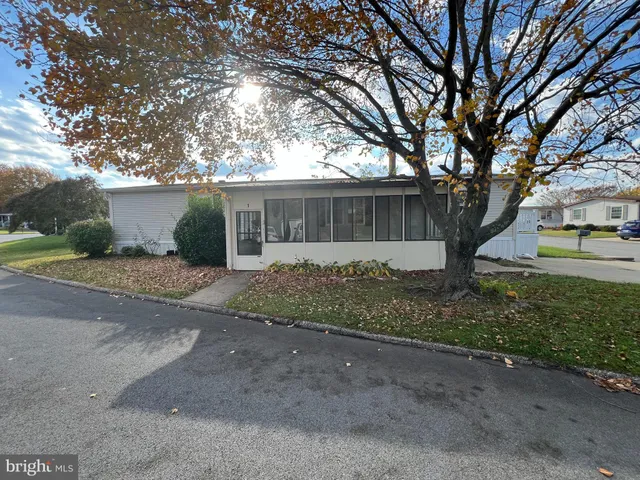 a front view of a house with a yard and a garage