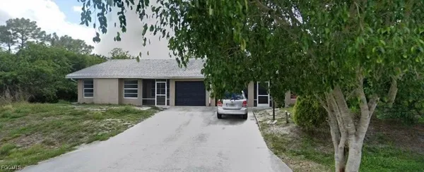 a view of a house with backyard sitting area and garden