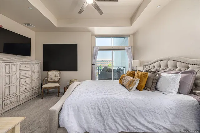 a bedroom with a bed a flat screen tv and dresser